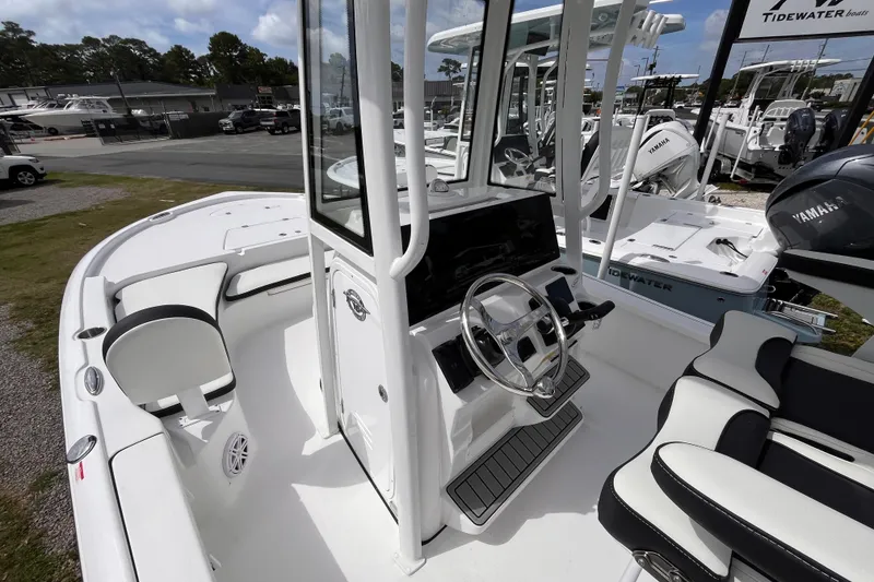 Slide: The Image of 2026 Tidewater 2210 Carolina Bay boat interior with steering console and seating. - 11