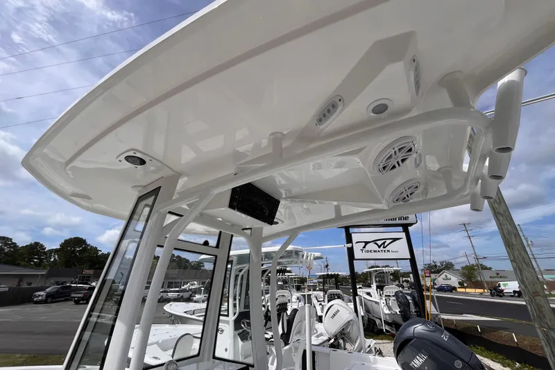 Slide: The Image of 2026 Tidewater 2210 Carolina Bay boat with T-top and Yamaha engine, displayed outdoors. - 12