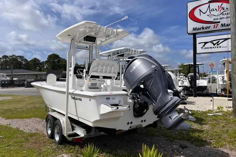 Slide: The Image of 2026 Tidewater 2210 Carolina Bay boat with Yamaha engine on trailer, dealership background. - 2