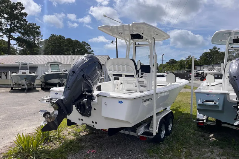 Slide: The Image of 2026 Tidewater 2210 Carolina Bay boat with outboard motor, parked on a trailer. - 3