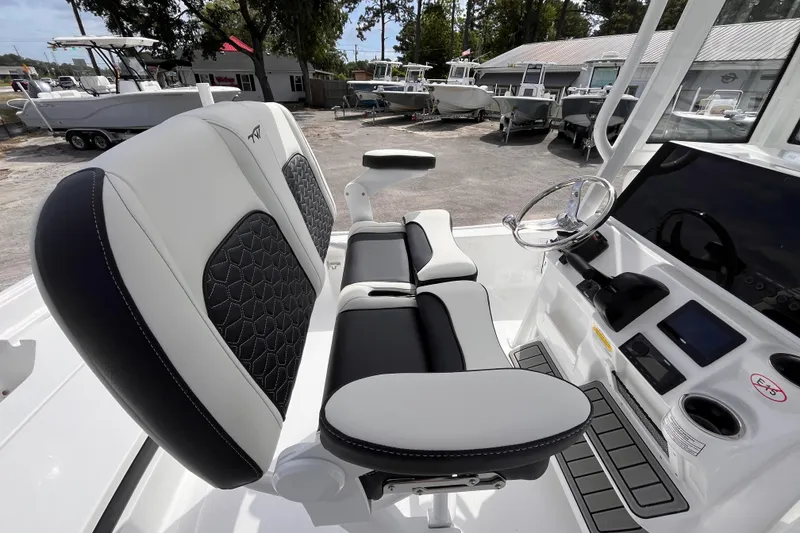 Slide: The Image of 2026 Tidewater 2210 Carolina Bay boat interior with modern seating and steering console. - 5