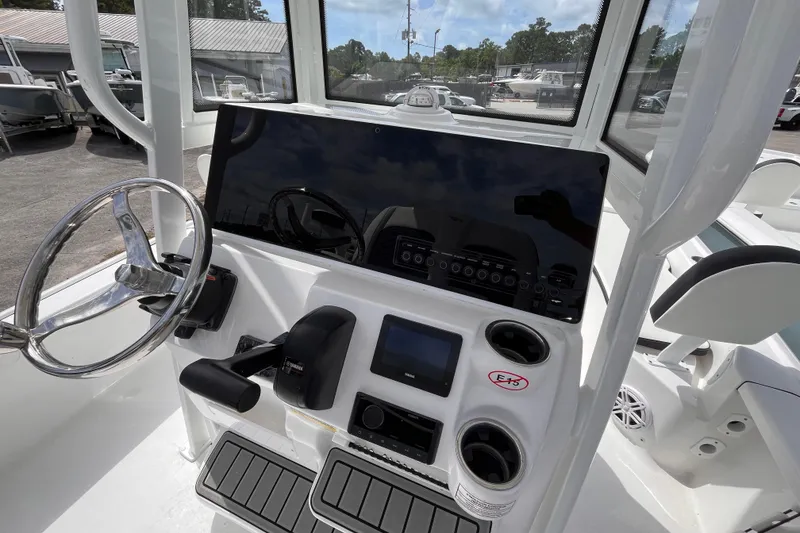 Slide: The Image of 2026 Tidewater 2210 Carolina Bay boat dashboard with steering wheel and electronic controls. - 6