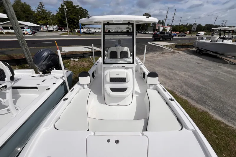 Slide: The Image of 2026 Tidewater 2210 Carolina Bay boat, white interior, parked outdoors, showcasing seating and console. - 9