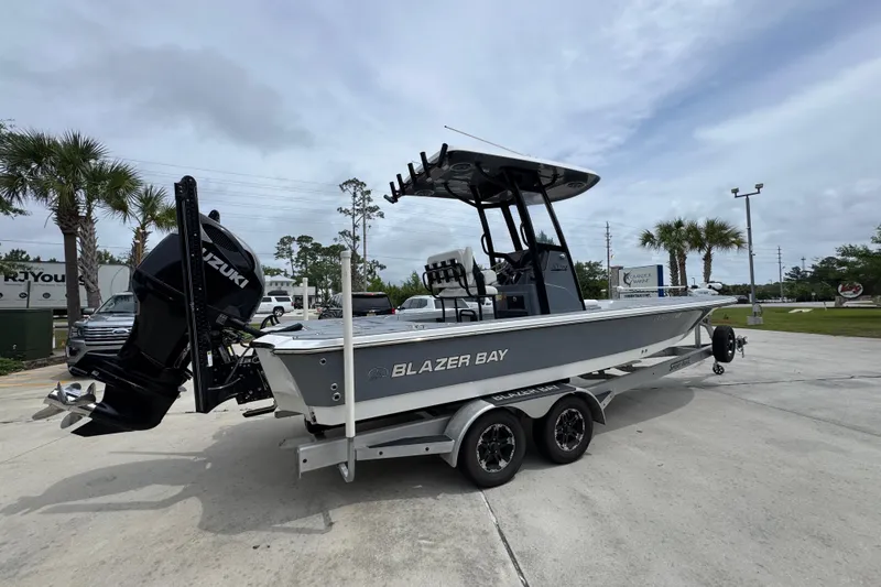 Slide: The Image of 2023 Blazer 2550 GTS boat on trailer with Suzuki outboard motor, parked outdoors. - 10