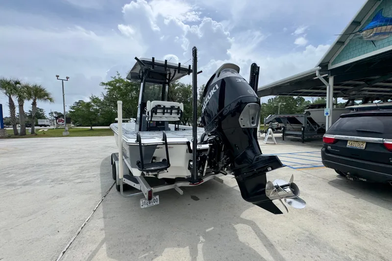Slide: The Image of 2023 Blazer 2550 GTS boat with Suzuki outboard motor in a parking lot. - 14