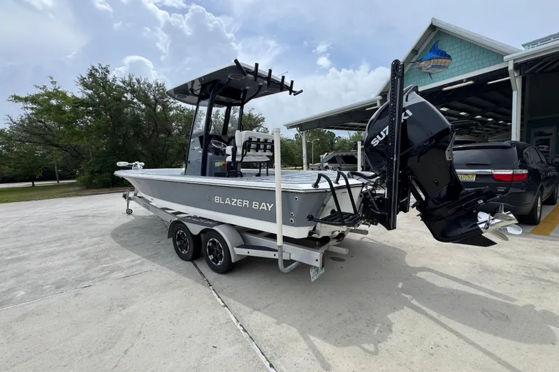 Slide: The Image of 2023 Blazer 2550 GTS boat with Suzuki engine on trailer, parked outdoors. - 15