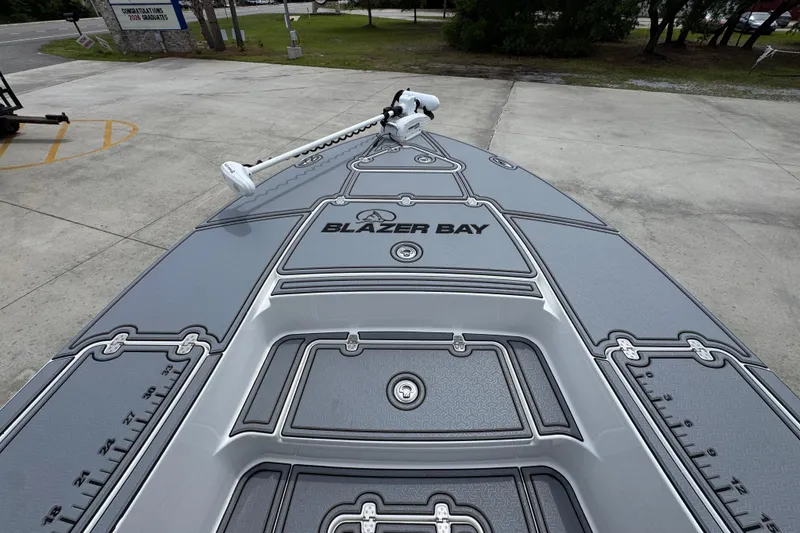 Slide: The Image of 2023 Blazer 2550 GTS boat deck with Blazer Bay branding, parked outdoors. - 17