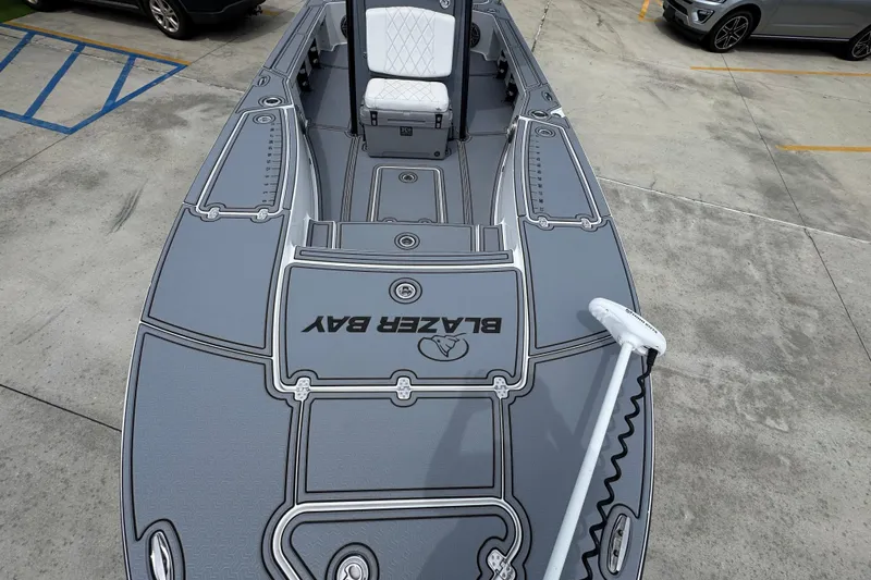 Slide: The Image of 2023 Blazer 2550 GTS boat with sleek gray deck design in parking lot. - 20
