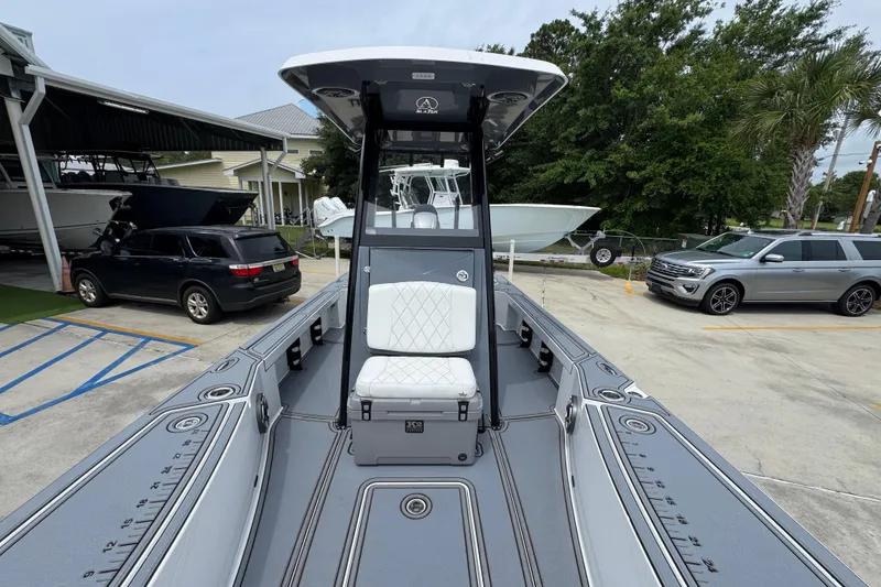 Slide: The Image of 2023 Blazer 2550 GTS boat with sleek design, parked outdoors. - 22