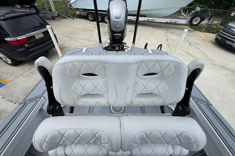 Slide: The Image of 2023 Blazer 2550 GTS boat seats with diamond stitching, parked near vehicles. - 26