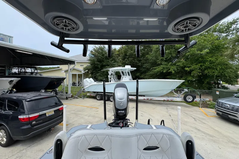 Slide: The Image of 2023 Blazer 2550 GTS boat in a marina with vehicles and trees. - 27