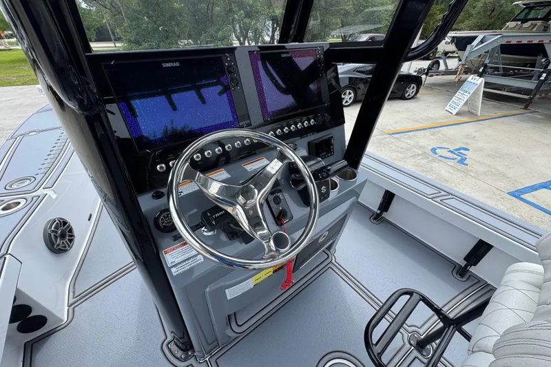 Slide: The Image of 2023 Blazer 2550 GTS boat dashboard with steering wheel and navigation screens. - 29