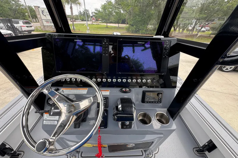 Slide: The Image of 2023 Blazer 2550 GTS boat dashboard with steering wheel and navigation screens. - 30