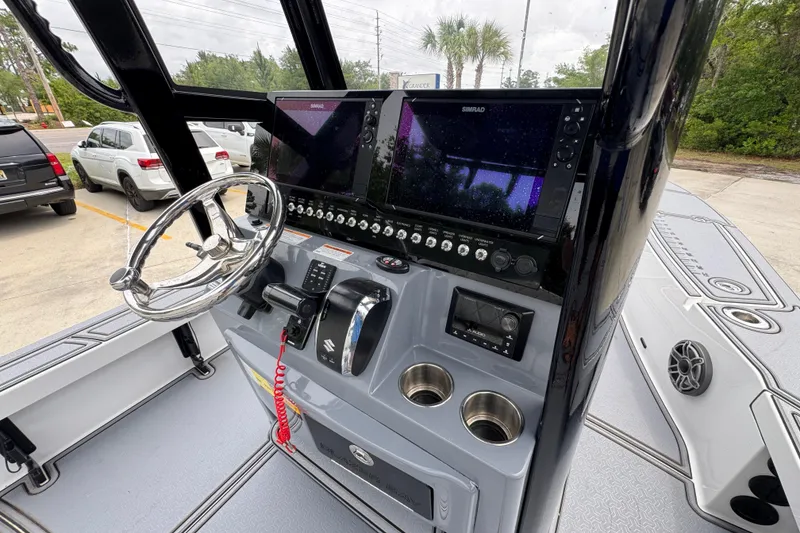 Slide: The Image of 2023 Blazer 2550 GTS boat dashboard with steering wheel and navigation controls. - 31