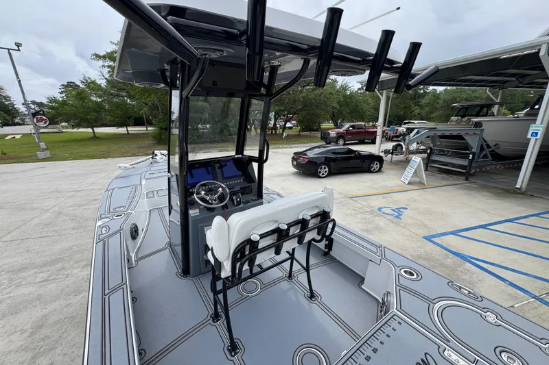 Slide: The Image of 2023 Blazer 2550 GTS boat with sleek design and modern console, parked outdoors. - 32