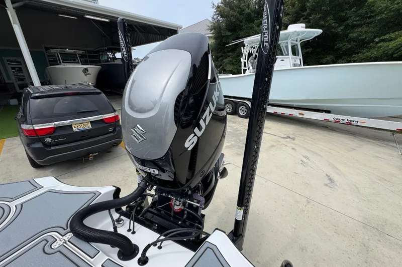 Slide: The Image of 2023 Blazer 2550 GTS with Suzuki outboard motor at a boat dealership. - 37