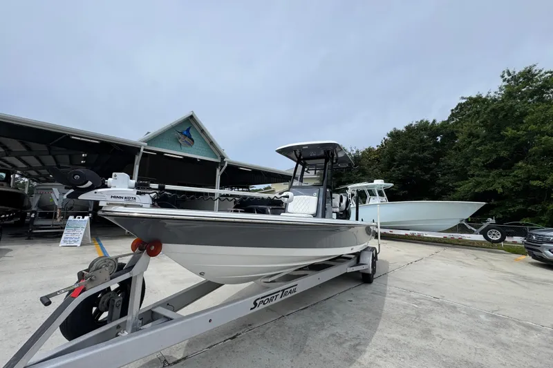 Slide: The Image of 2023 Blazer 2550 GTS boat on trailer at dealership, featuring Minn Kota motor. - 4