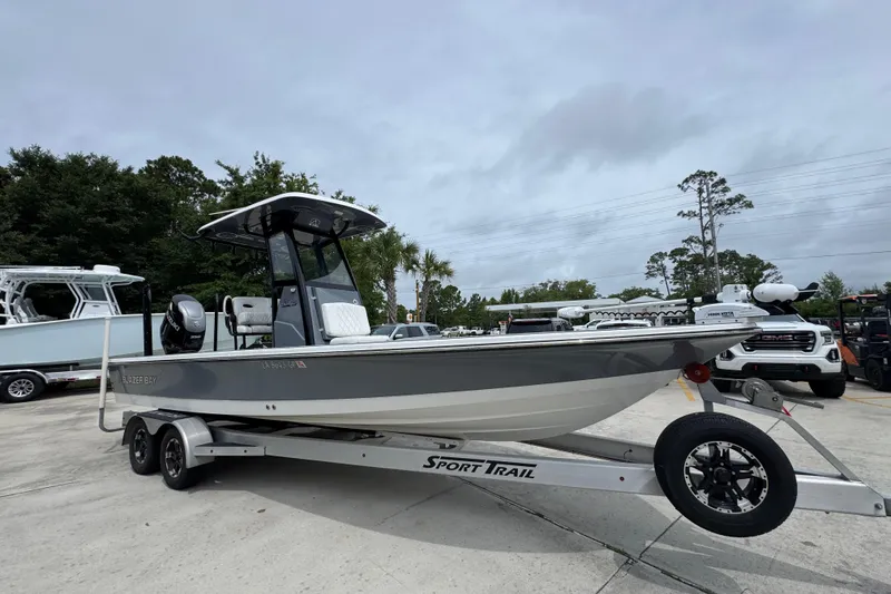 Slide: The Image of 2023 Blazer 2550 GTS boat on trailer, parked outdoors under cloudy sky. - 7