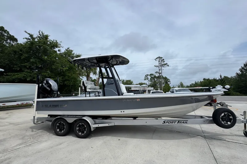 Slide: The Image of 2023 Blazer 2550 GTS boat on trailer, parked outdoors, side view. - 8