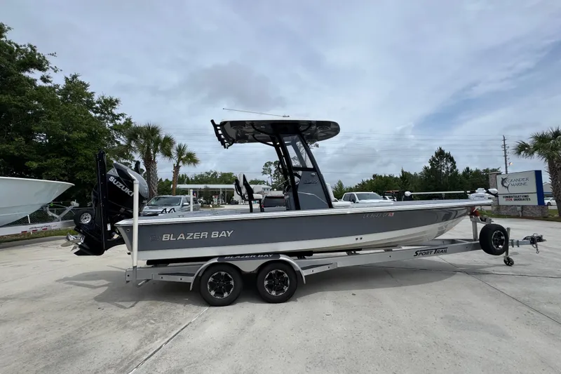 Slide: The Image of 2023 Blazer 2550 GTS boat on trailer, parked outdoors, featuring sleek design and Suzuki engine. - 9