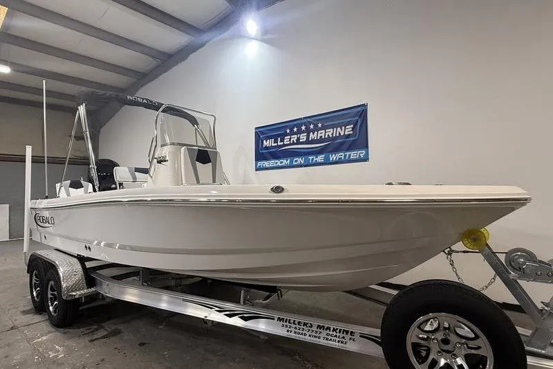 Slide: The Image of 2026 Robalo 206 Cayman boat on trailer in warehouse. - 1