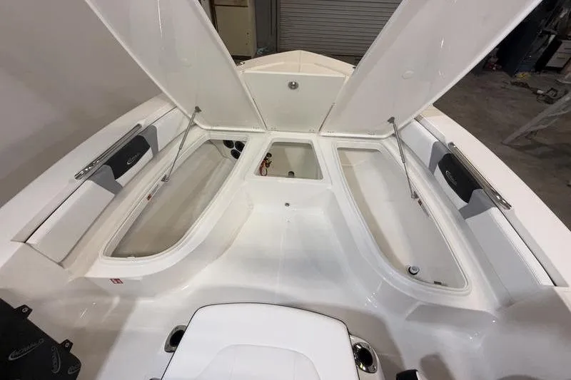 Slide: The Image of Interior view of 2026 Robalo 206 Cayman boat with open storage compartments. - 15