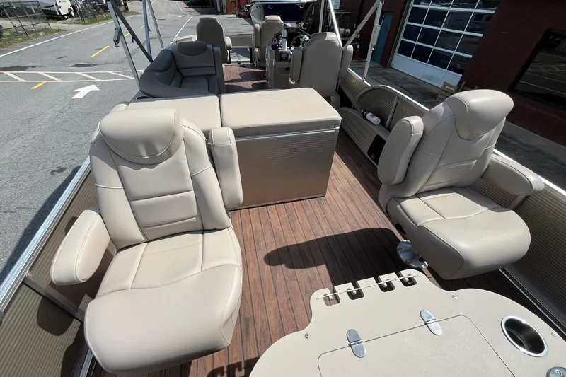 Slide: The Image of Interior of a 2018 Avalon QF-23T pontoon boat with beige leather seats. - 14
