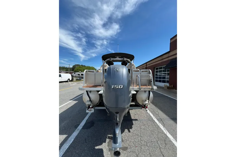 Slide: The Image of Rear view of Avalon QF-23T boat, 2018 model, featuring outboard motor. - 6