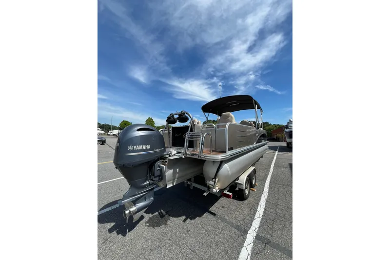Slide: The Image of 2018 Avalon QF-23T boat with Yamaha engine parked outdoors. - 8