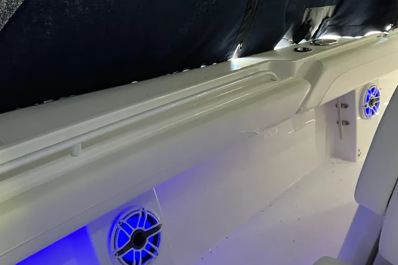 Slide: The Image of Interior of 2025 Regulator 28 boat with blue LED lighting and speakers. - 12