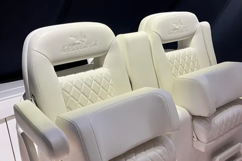 Slide: The Image of Luxurious white seating on 2025 Regulator 28 boat, featuring diamond stitching and embossed logo. - 4