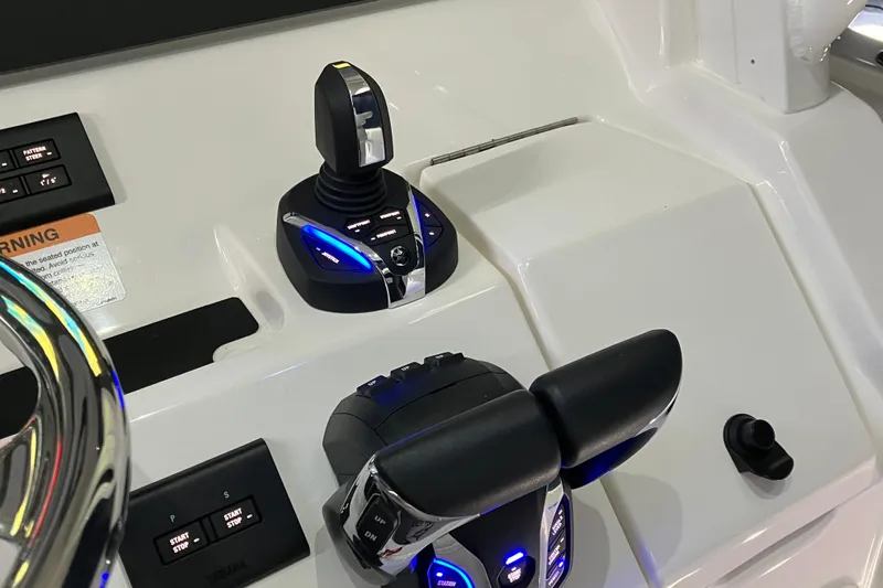 Slide: The Image of Control panel of 2025 Regulator 28 boat with joystick and throttle levers. - 9