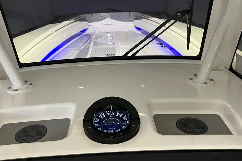 Slide: The Image of 2025 Regulator 28 boat dashboard with compass and windshield view. - 5