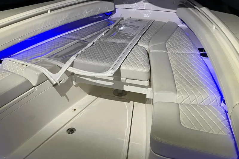 Slide: The Image of Luxurious interior of 2025 Regulator 28 boat with blue LED lighting and quilted seating. - 11