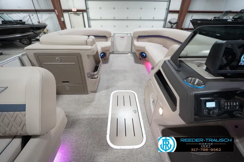 Slide: The Image of Interior of 2026 Bennington 22 ML pontoon boat with modern seating and ambient lighting. - 24