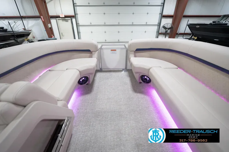 Slide: The Image of 2026 Bennington 22 ML pontoon boat interior with ambient purple lighting. - 25