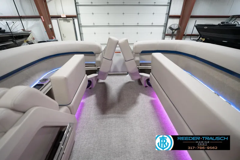 Slide: The Image of 2026 Bennington 22 ML boat interior with plush seating and ambient lighting. - 26