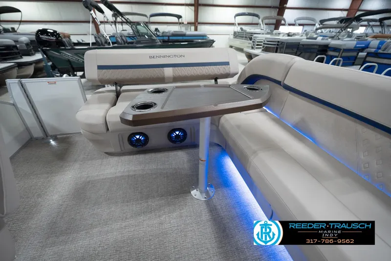 Slide: The Image of 2026 Bennington 22 ML pontoon boat interior with seating, table, and blue LED lighting. - 38