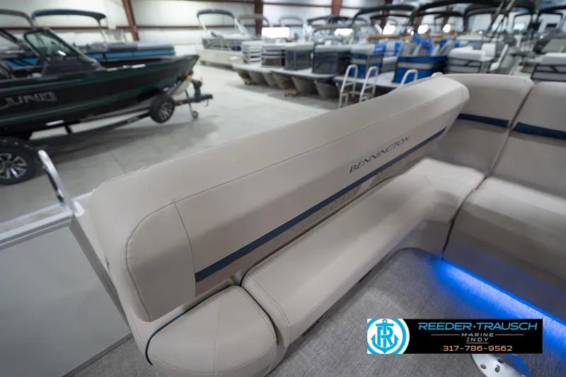 Slide: The Image of 2026 Bennington 22 ML pontoon boat interior with beige seating and blue accent lighting. - 42
