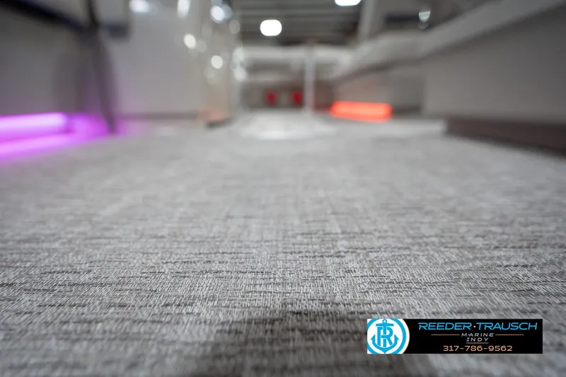 Slide: The Image of Carpeted interior of 2026 Bennington 22 ML boat with ambient lighting. - 60