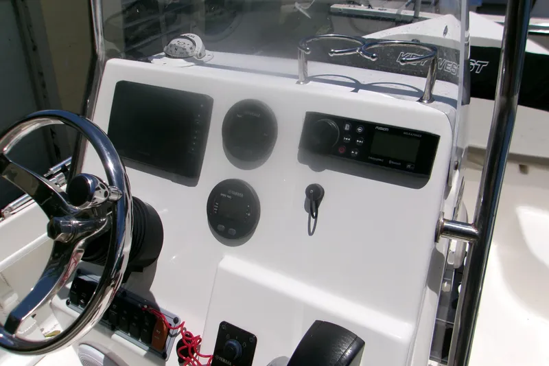 Slide: The Image of 2022 Key West 1720 Center Console boat dashboard with steering wheel and electronic controls. - 6