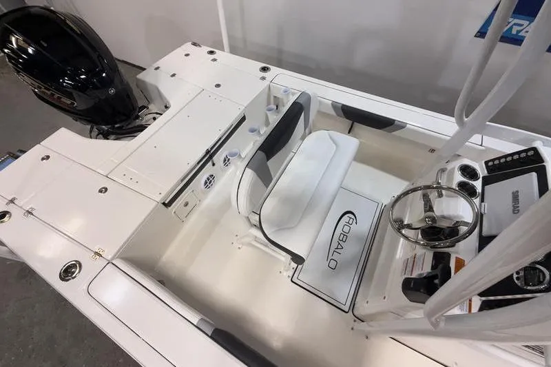 Slide: The Image of 2026 Robalo 226 Cayman boat interior with steering wheel and seating area. - 10