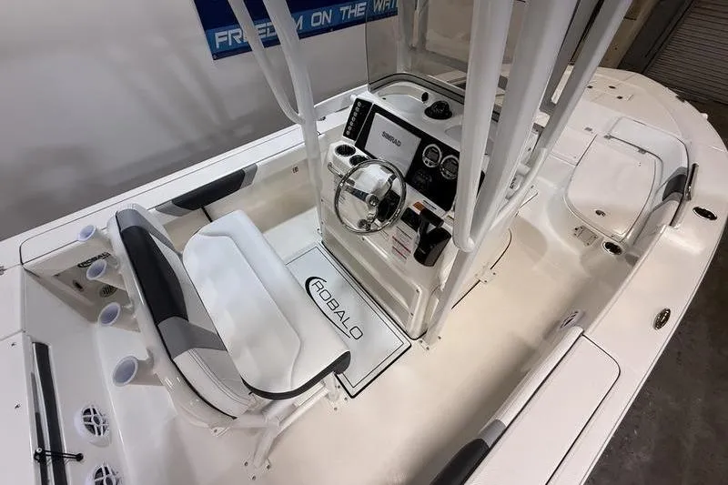 Slide: The Image of 2026 Robalo 226 Cayman boat interior with steering console and seating. - 11