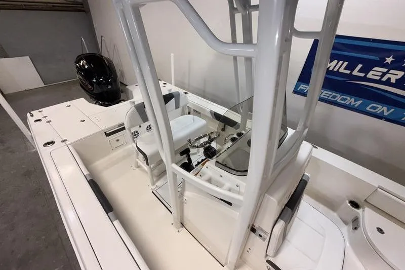 Slide: The Image of 2026 Robalo 226 Cayman boat interior with steering console and seating. - 12
