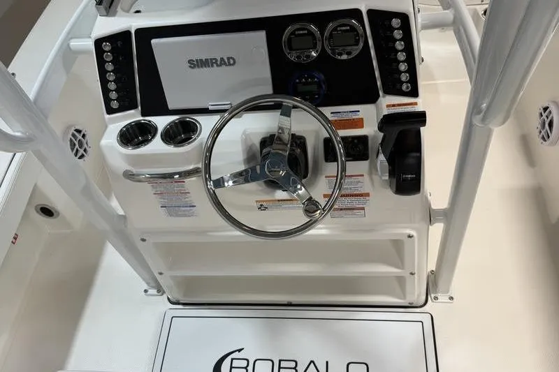 Slide: The Image of 2026 Robalo 226 Cayman boat dashboard with steering wheel and Simrad display. - 14