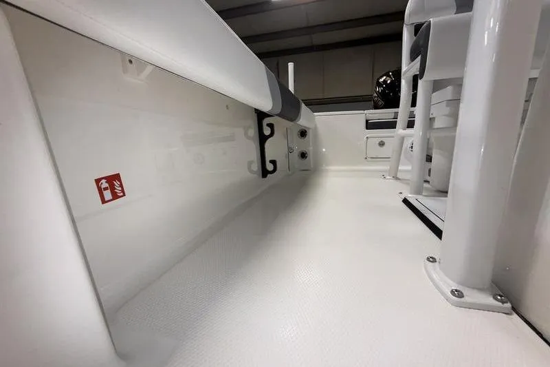Slide: The Image of 2026 Robalo 226 Cayman boat interior, showcasing sleek white deck and seating area. - 16