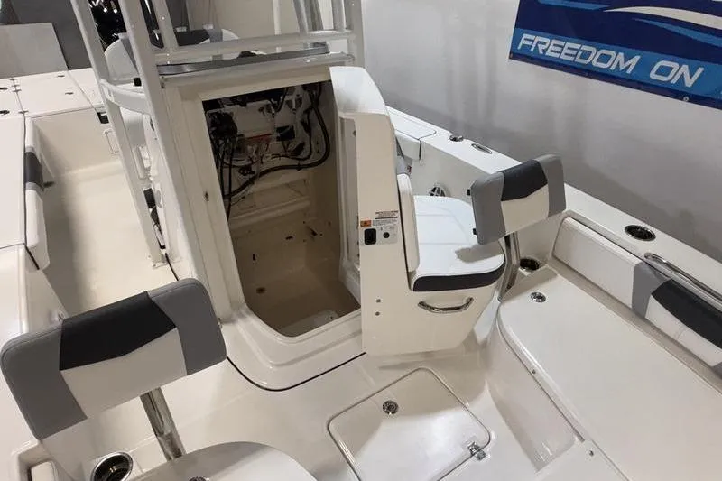 Slide: The Image of 2026 Robalo 226 Cayman boat interior with open storage compartment and seating. - 18