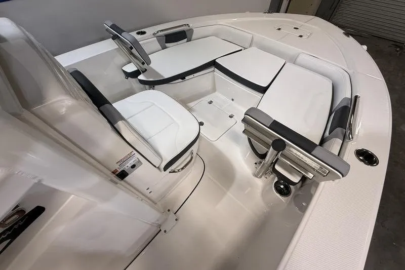 Slide: The Image of 2026 Robalo 226 Cayman boat interior with white seating and steering console. - 20
