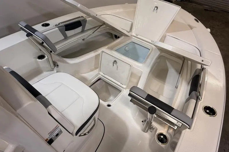 Slide: The Image of 2026 Robalo 226 Cayman boat interior with seating and storage compartments. - 21