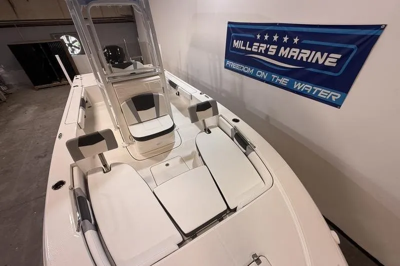 Slide: The Image of 2026 Robalo 226 Cayman boat displayed indoors at Miller's Marine showroom. - 22